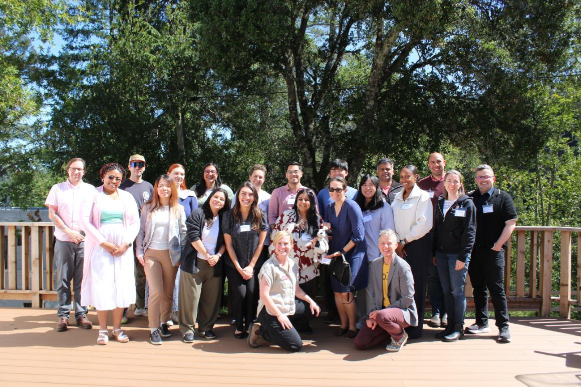 faculty standing on deck in the sun posing for group photo