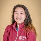 A person in a red jacket smiling. Text: Jessica Hou.