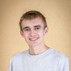 Young person smiling against a beige background. Justin Cole Class of 2021.