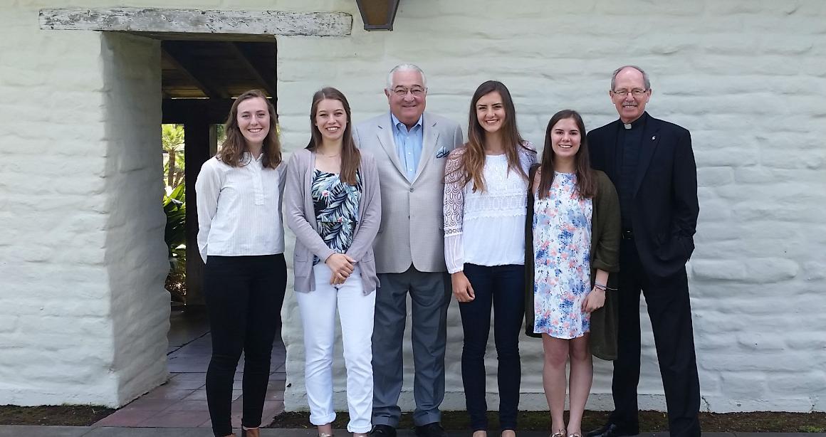 Four Robert Warren Scholars by the Adobe Wall with Robert Warren and Fr. Engh after a luncheon.