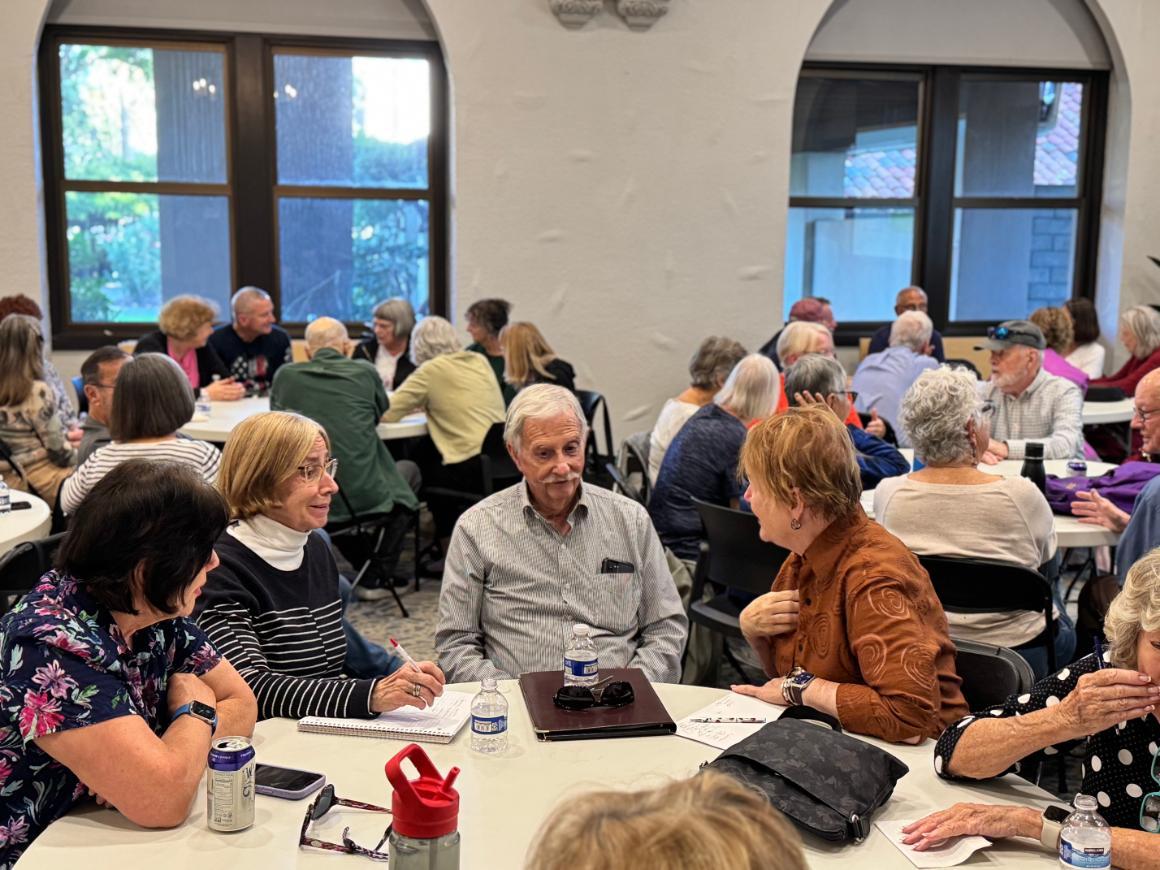 Seated audience of retired faculty in discussion
