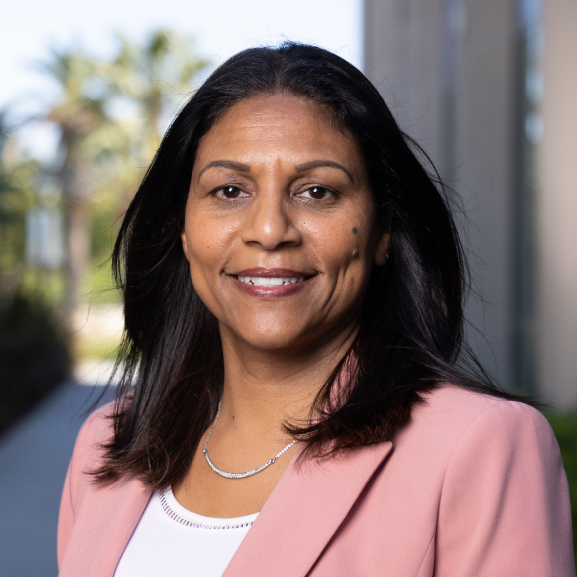 Thiadora Pina Profile pink jacket smiles at camera