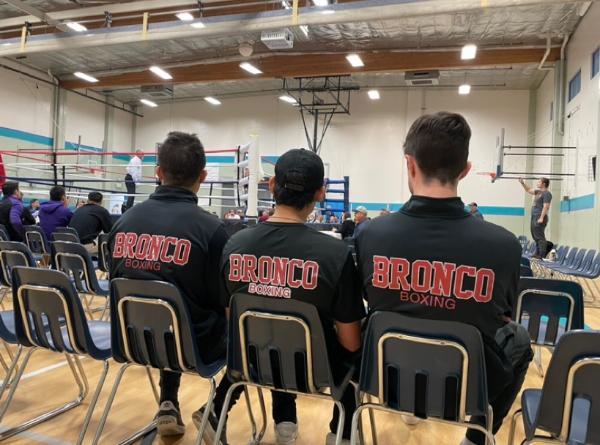 3 students on the boing team watch a match
