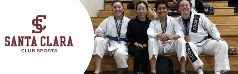 Picture shows 4 smiling people after a Shotokan tournament.
