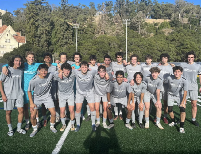 Image of Men's Club Soccer team after a game. They are standing together smiling.