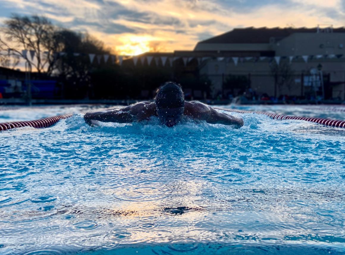 Swimmer swimming butterfly in outdoor pool