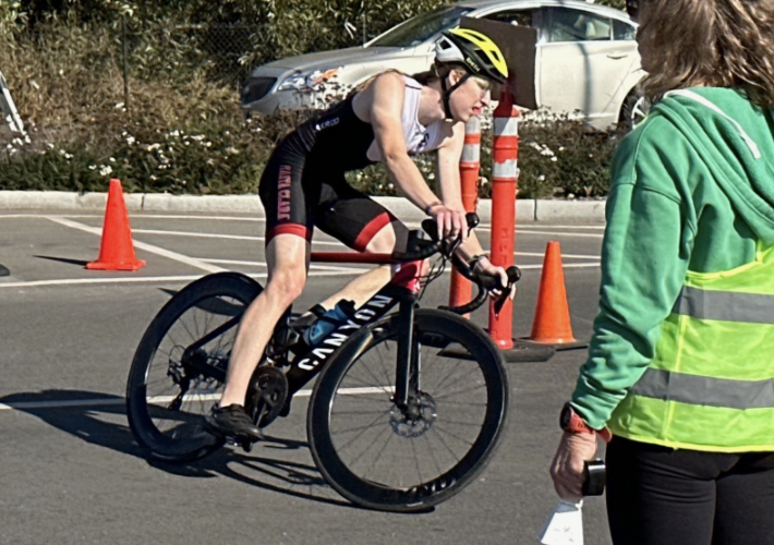 This picture shows an individual on the bike portion of the race, rounding a corner.