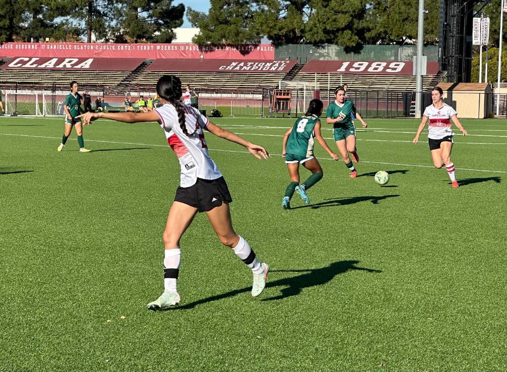 Women's Club Soccer players passing the ball during Sac State game