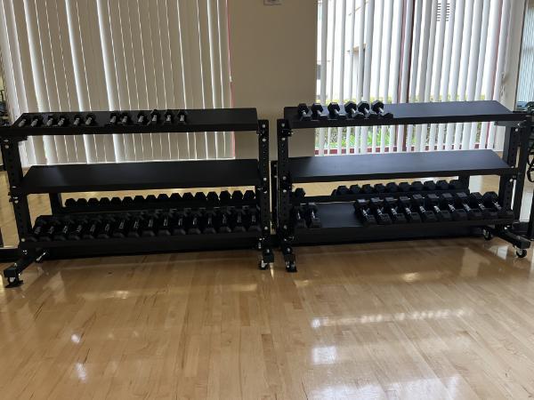 two dumbbell racks in the Malley Center Multipurpose Room with weights on them