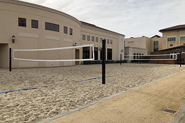 image of sand volleyball court behind malley