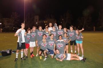 A soccer team posing on a field at night. image link to story