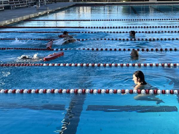 Image of lifeguards rescuing one another in 3 lanes of the pool