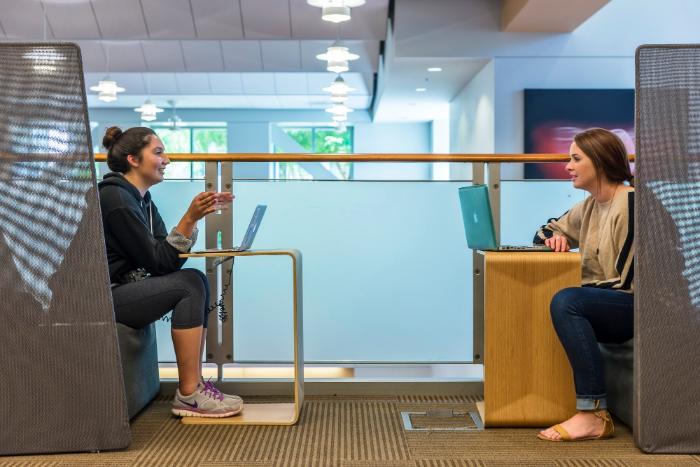 Two students talking in the Learning Commons