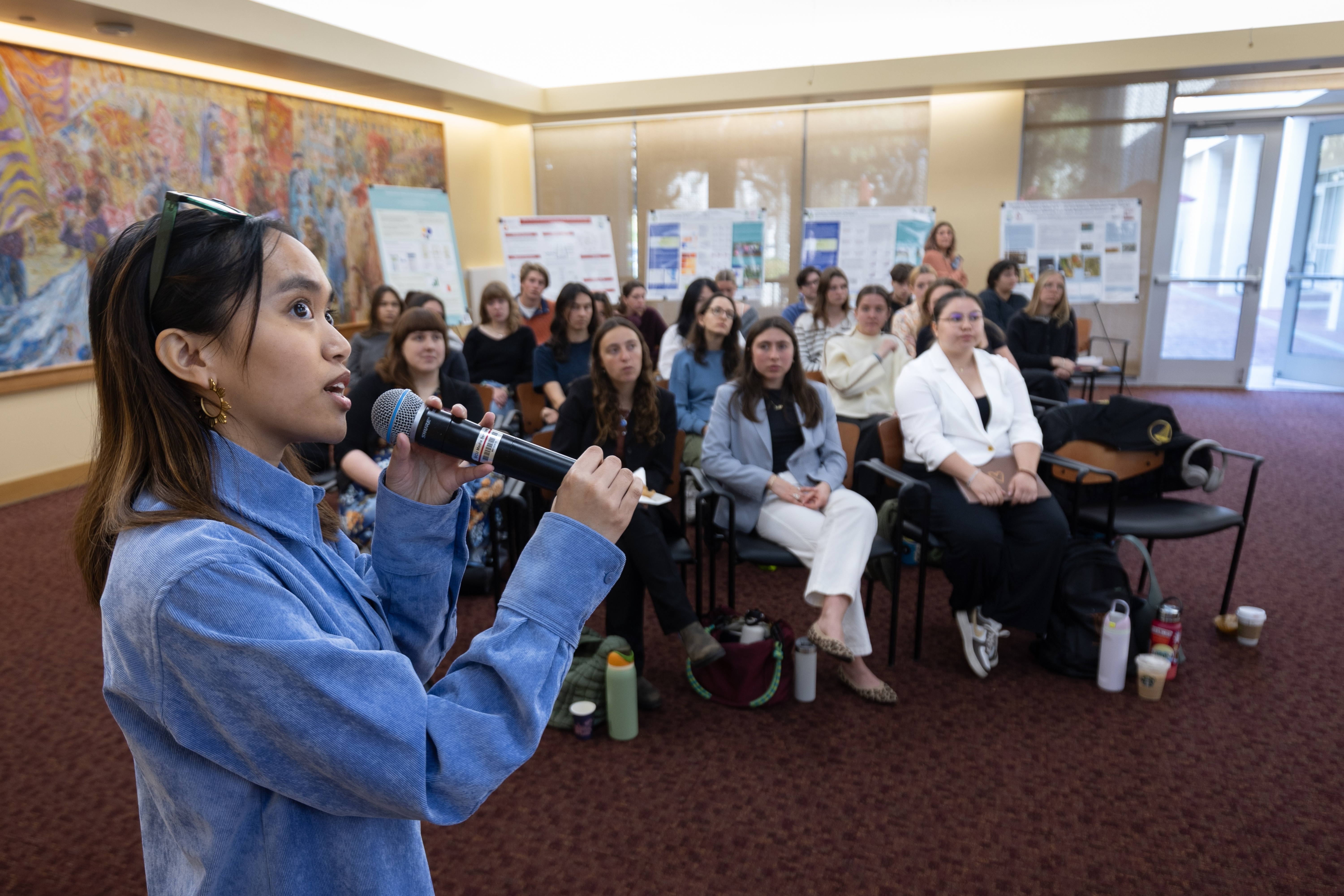 A student shares their research with an audience during the 2025 Sustainability and EJ Symposium.