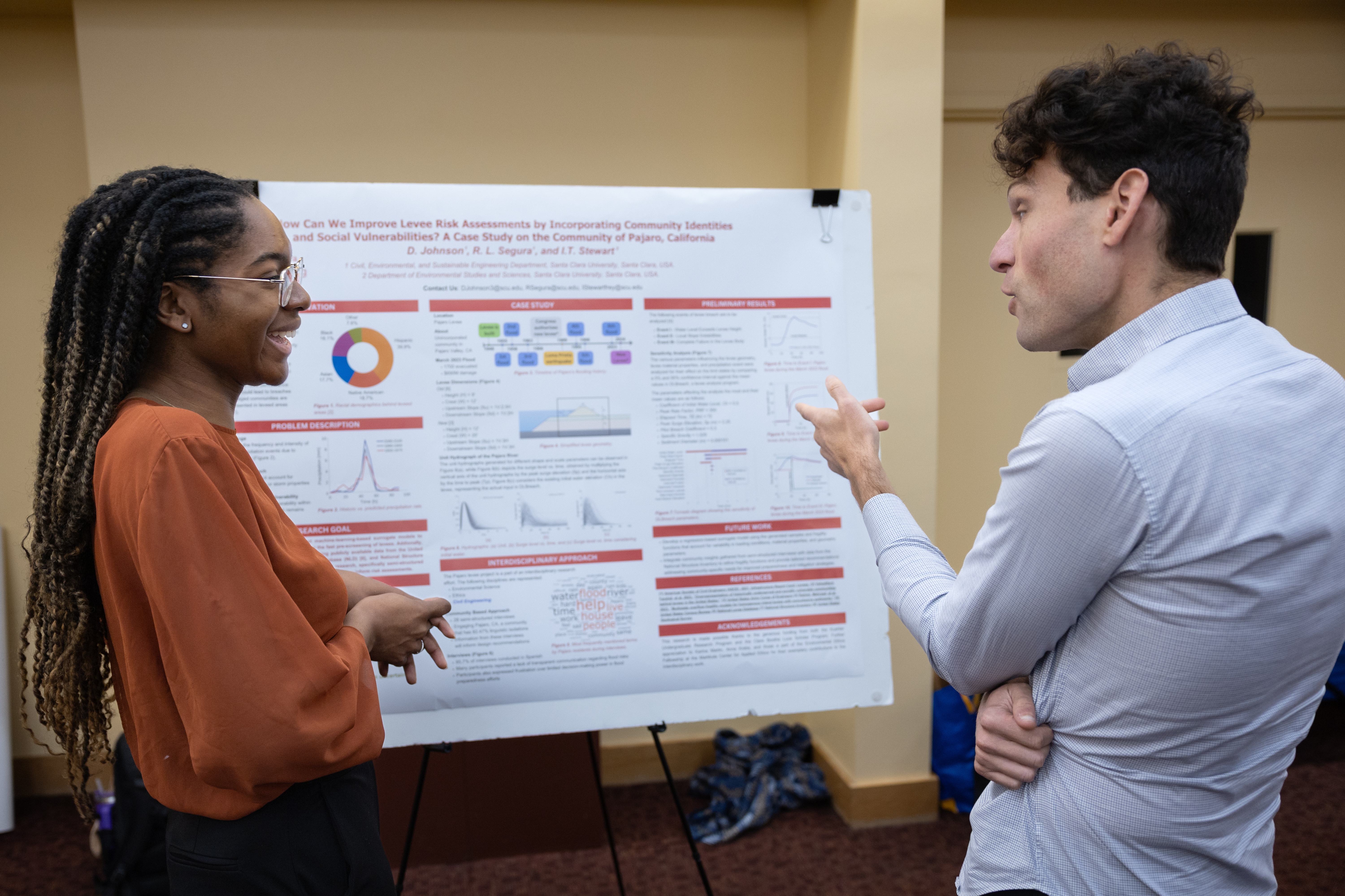 A student shares their research with a faculty member during the 2025 Sustainability and EJ Symposium.