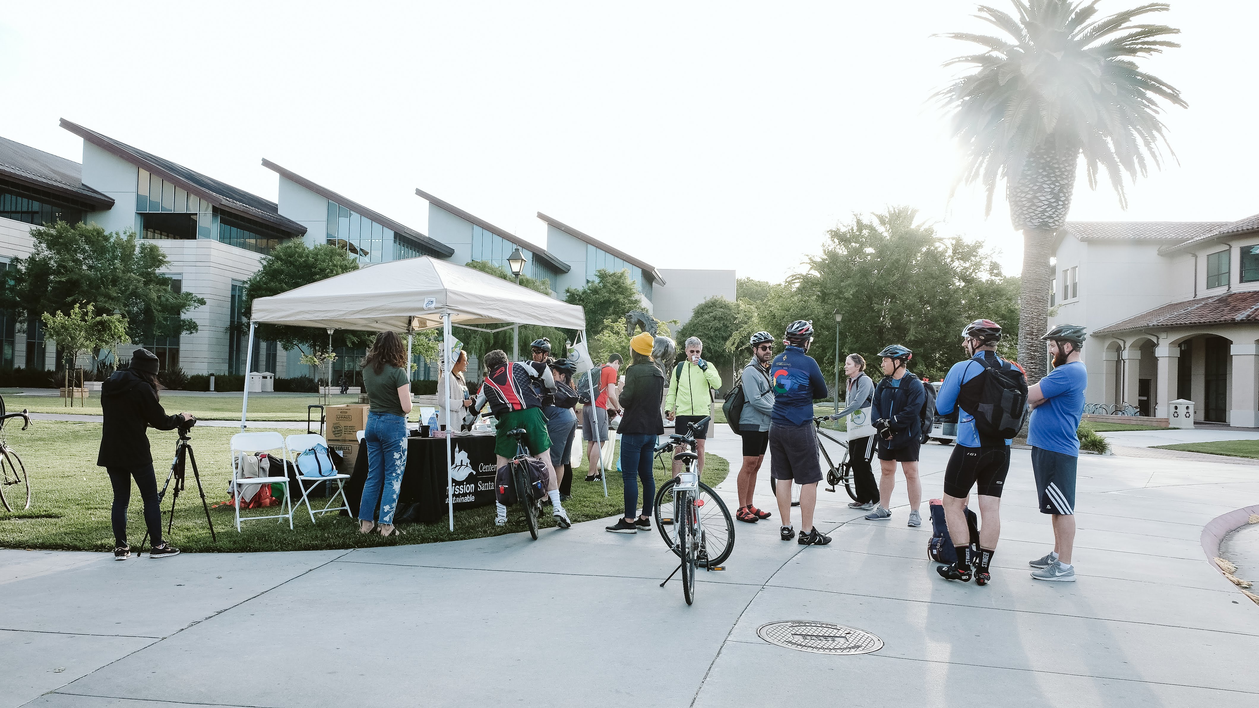 Many cyclists gathering near SCU's Energizer Station for snacks and goodies.