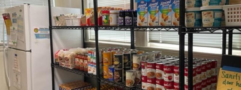 Shelves of pantry items next to a fridge. Photo from Bronco Pantry. 