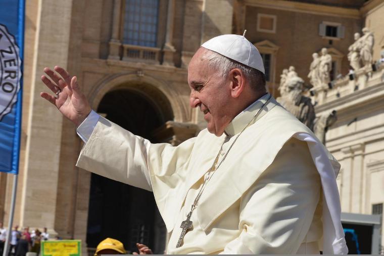 Pope Francis waving outside a building