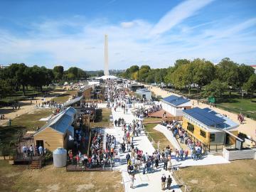 Houses set up along the National Mall with people touring through them