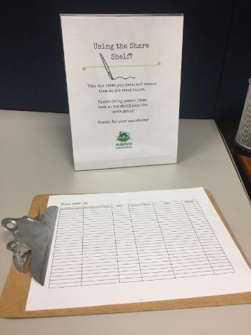 Laminated sign instructing to take items from the shelf, and a clipboard with a clean sign in sheet