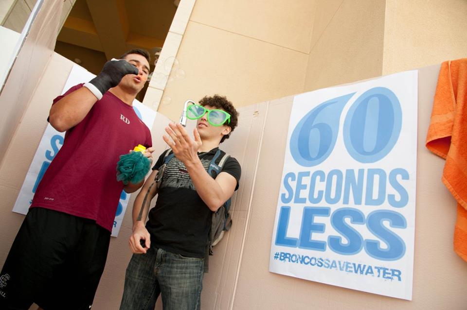 Two people standing near a sign that reads 