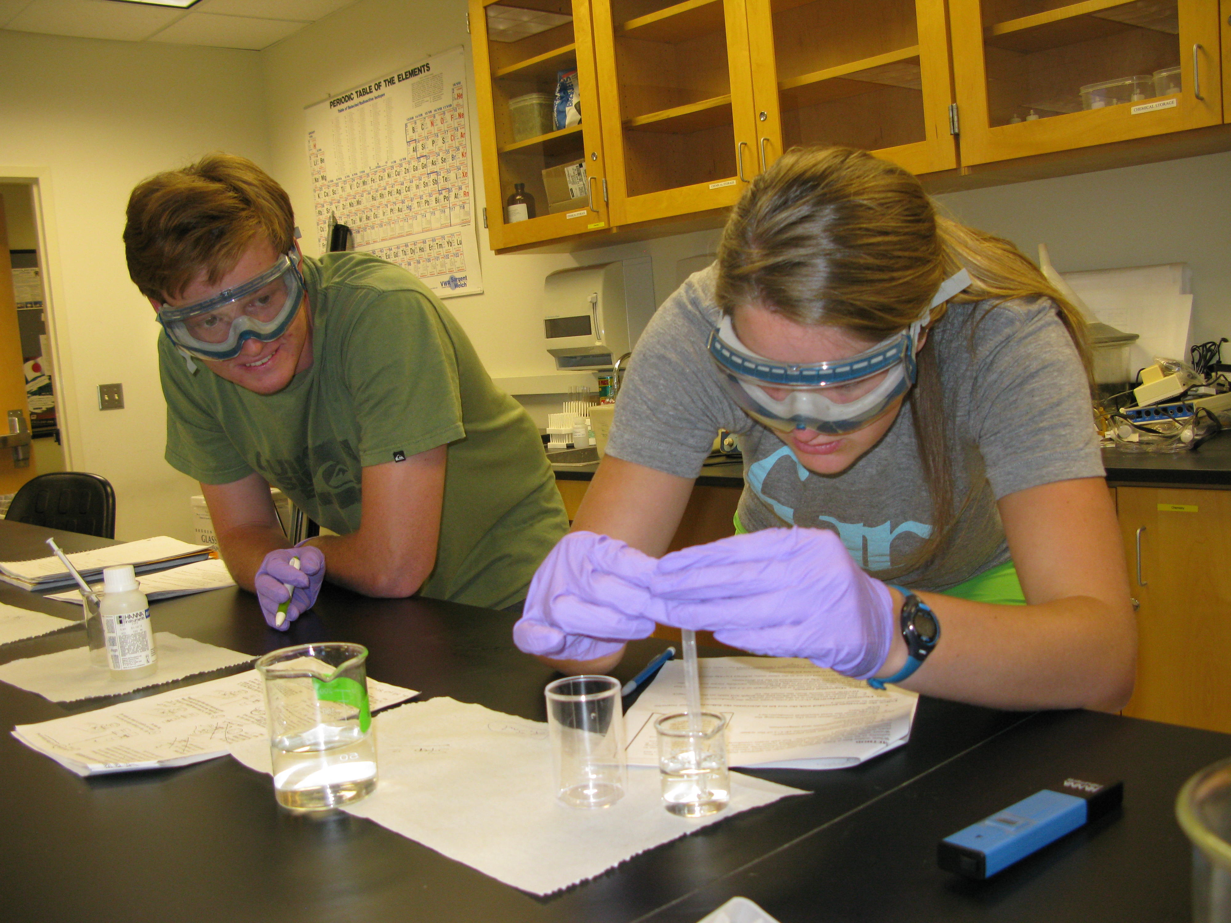 Students working in a science lab with various equipment.