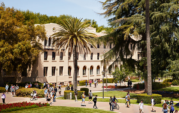 SCU students walk and ride across campus. image link to story