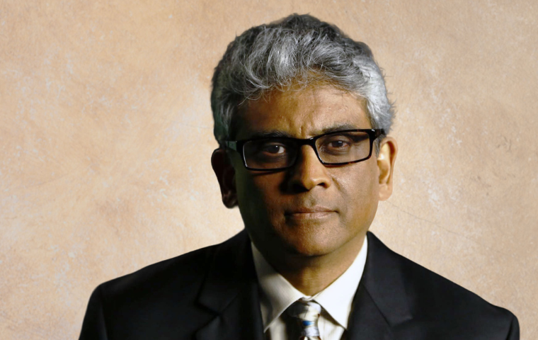 Journalist in Residence Fred de Sam Lazaro in front of a beige background.