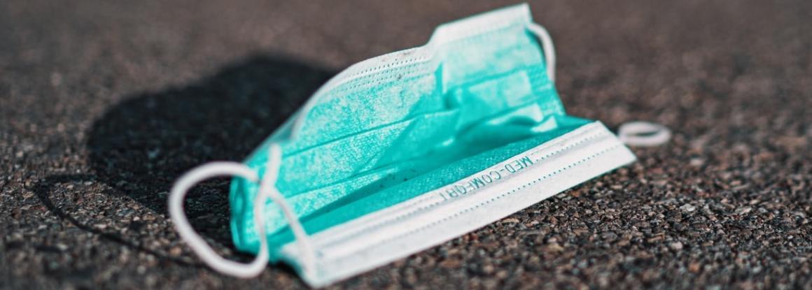 Photograph of a surgical mask on the street.