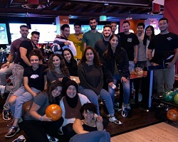 Group of people at a bowling alley.