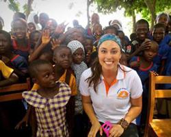 Stephanie Goodman posing with young girl in Ghana.