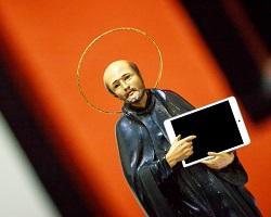 Icon of St. Ignatius holding and iPad.