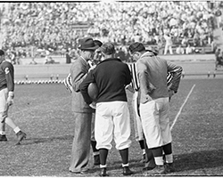Black-and-white photo of Coach Buck Shaw on the field.