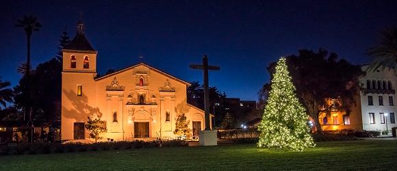 Santa Clara Mission with a lit Christmas Tree in front