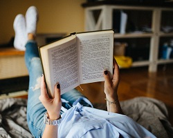 Person laying down reading