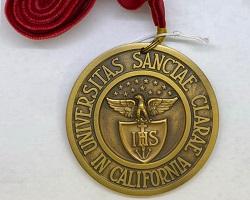 Gold medallion on a red velvet lanyard.