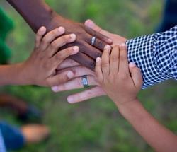 Group of people touching hands together.