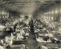 Historic photograph of patients in an infirmary during the 1918 Spanish flu outbreak. 