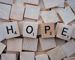 Scrabble tiles spelling the word HOPE.