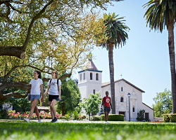 Three students walking near the Mission Church.