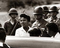1950s black and white photo of African American women and Caucasian American soldiers.