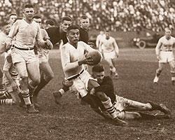 Sports photo of Rudy Scholtz playing rugby c. 1920.
