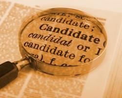 Magnifying glass over dictionary definition of candidate.
