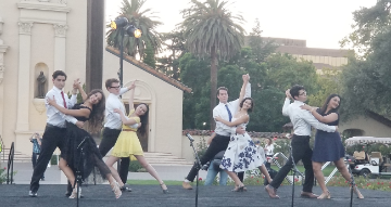 Group of SCU alumni ballroom dancing in front of the Mission Church