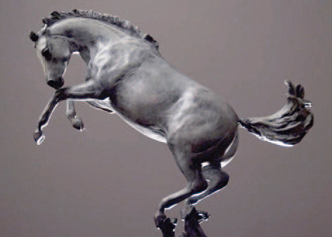 A gray metal statue of a bucking bronco facing left on a gray background