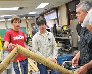 People examining bamboo in a workshop setting.