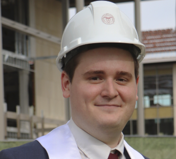 Alumnus Devin Schmidt wearing a SCU hardhat.