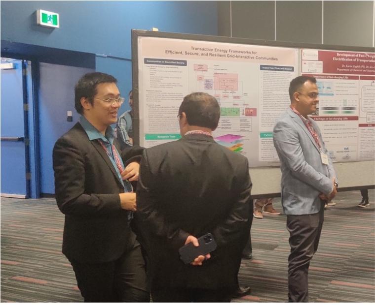 three people standing next to a poster