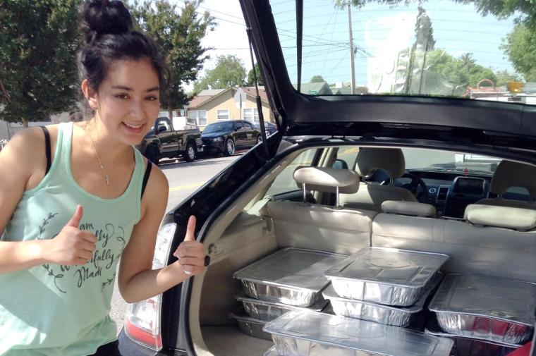Makena Wong drops off a carload of food at Martha's Kitchen. image link to story