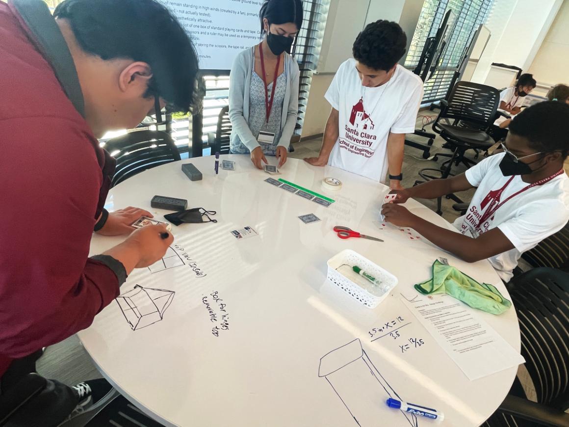 Four diverse high school students participate in an engineering activity during the 2022 SES Program